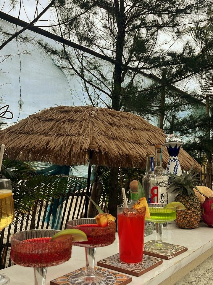 Pink margaritas and a tropical highball with pineapple garnish